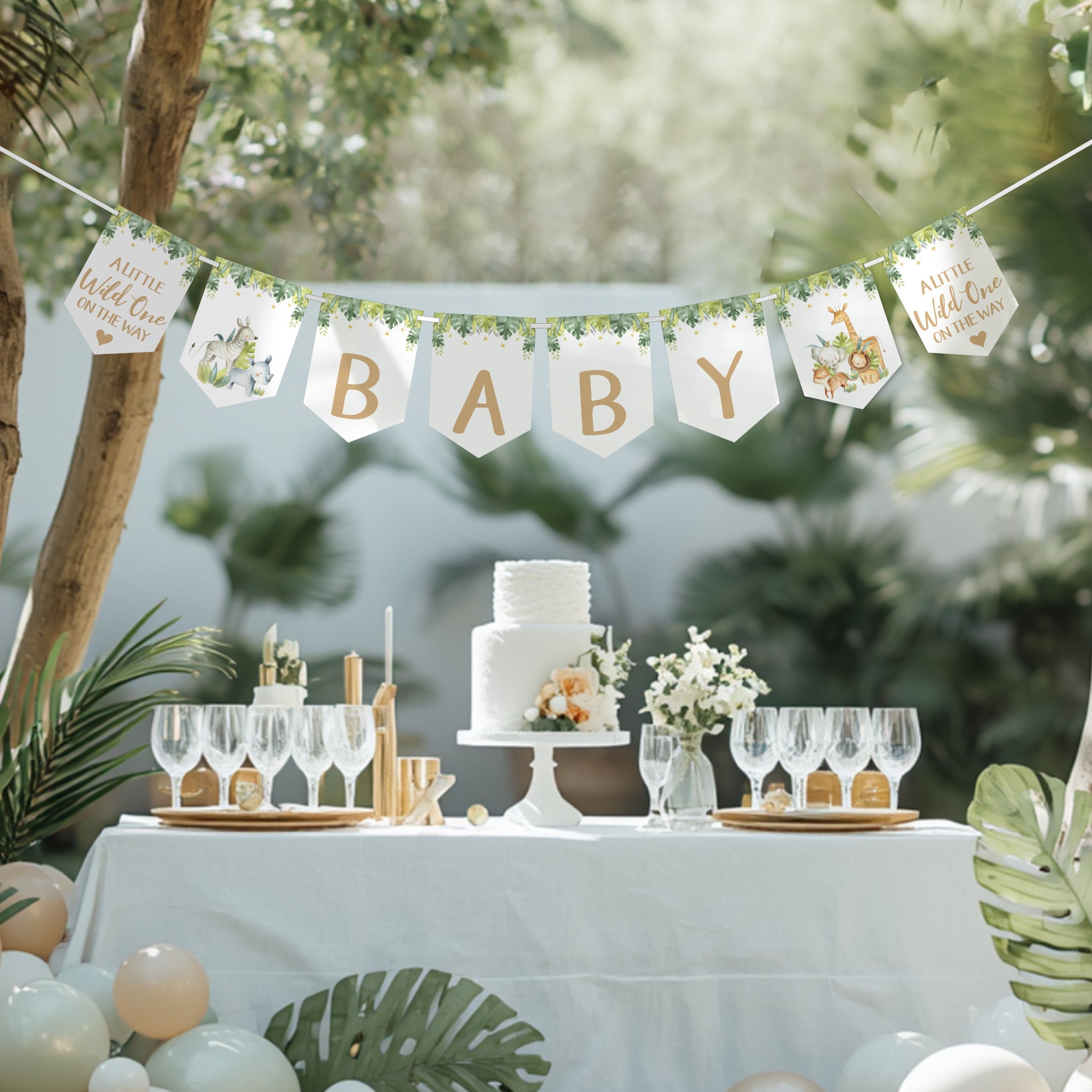 Safari baby shower banner with jungle animals and "BABY" bunting displayed above a decorated baby shower table.