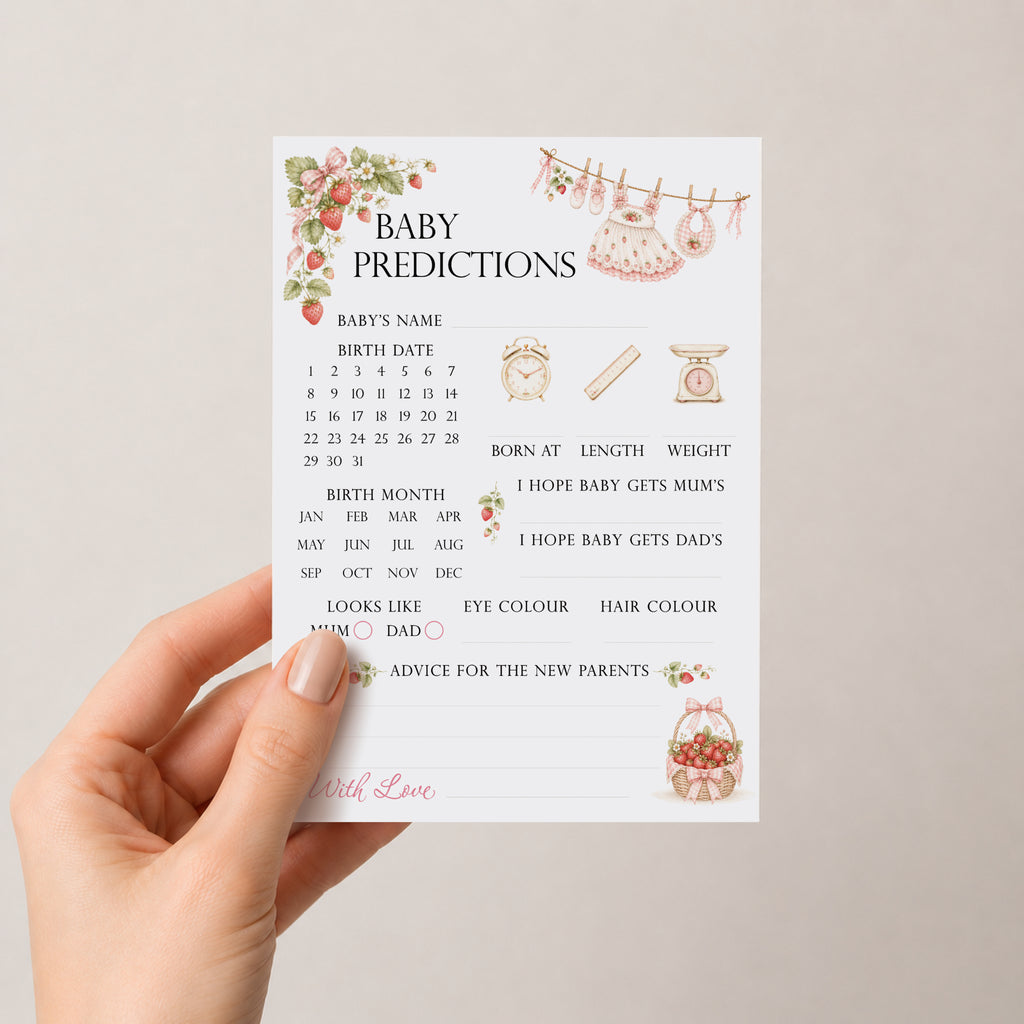 Hand holding Berry Sweet Baby A6 strawberry baby shower prediction keepsake card against a soft neutral background.