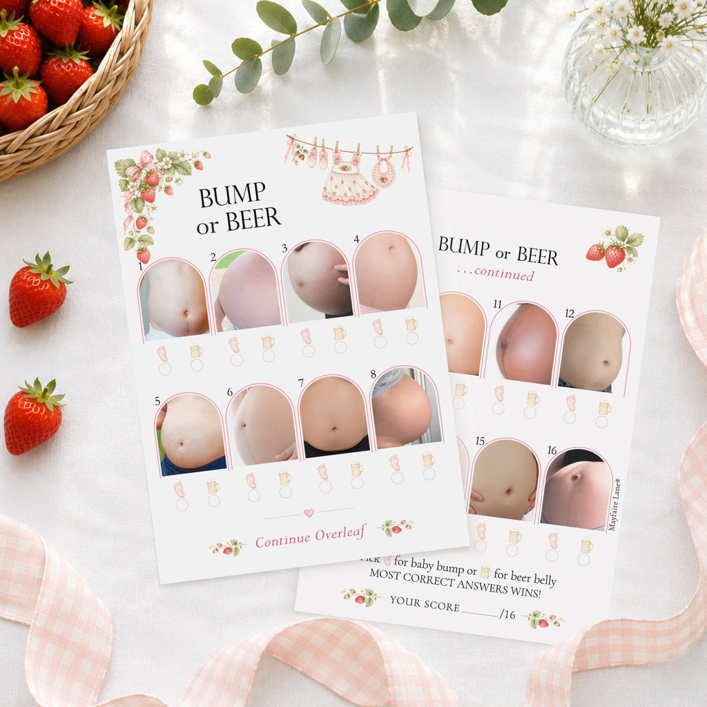 Berry Sweet Baby Bump or Beer double-sided A6 baby shower game cards styled with strawberries and elegant party décor arranged on a white surface with strawberries, a woven basket, greenery, and pink gingham ribbon around them. The cards show numbered belly photos and decorative floral accents.