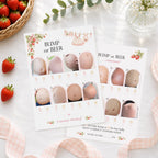Berry Sweet Baby Bump or Beer double-sided A6 baby shower game cards styled with strawberries and elegant party décor arranged on a white surface with strawberries, a woven basket, greenery, and pink gingham ribbon around them. The cards show numbered belly photos and decorative floral accents.