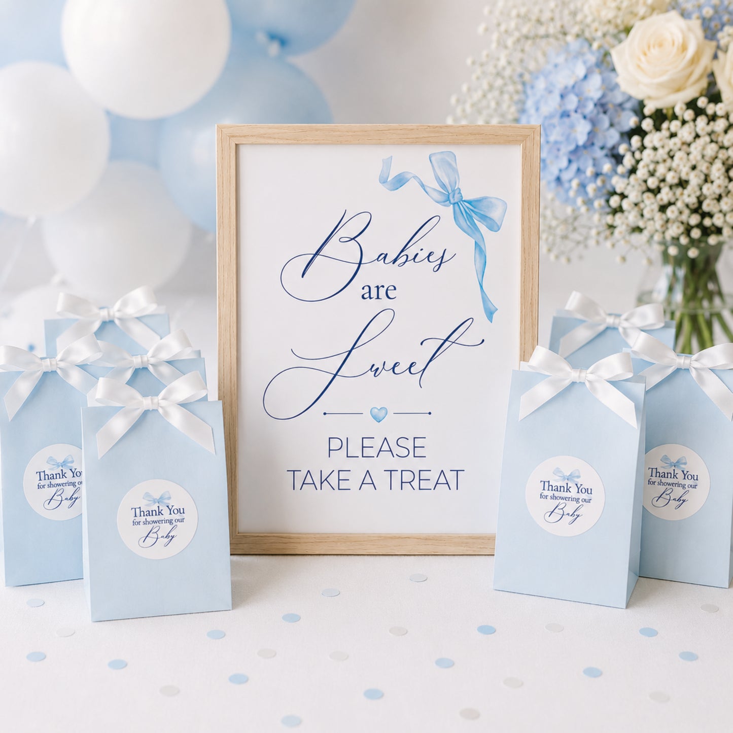 Blue bow baby shower favour sign displayed with gift bags and matching thank you stickers, baby boy baby shower decoration inspiration