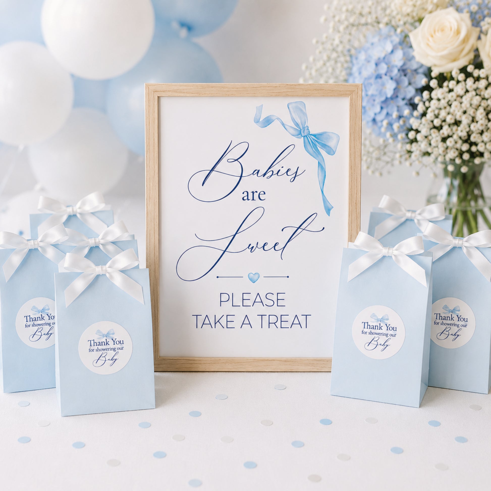 Blue bow baby shower favour sign displayed with gift bags and matching thank you stickers, baby boy baby shower decoration inspiration