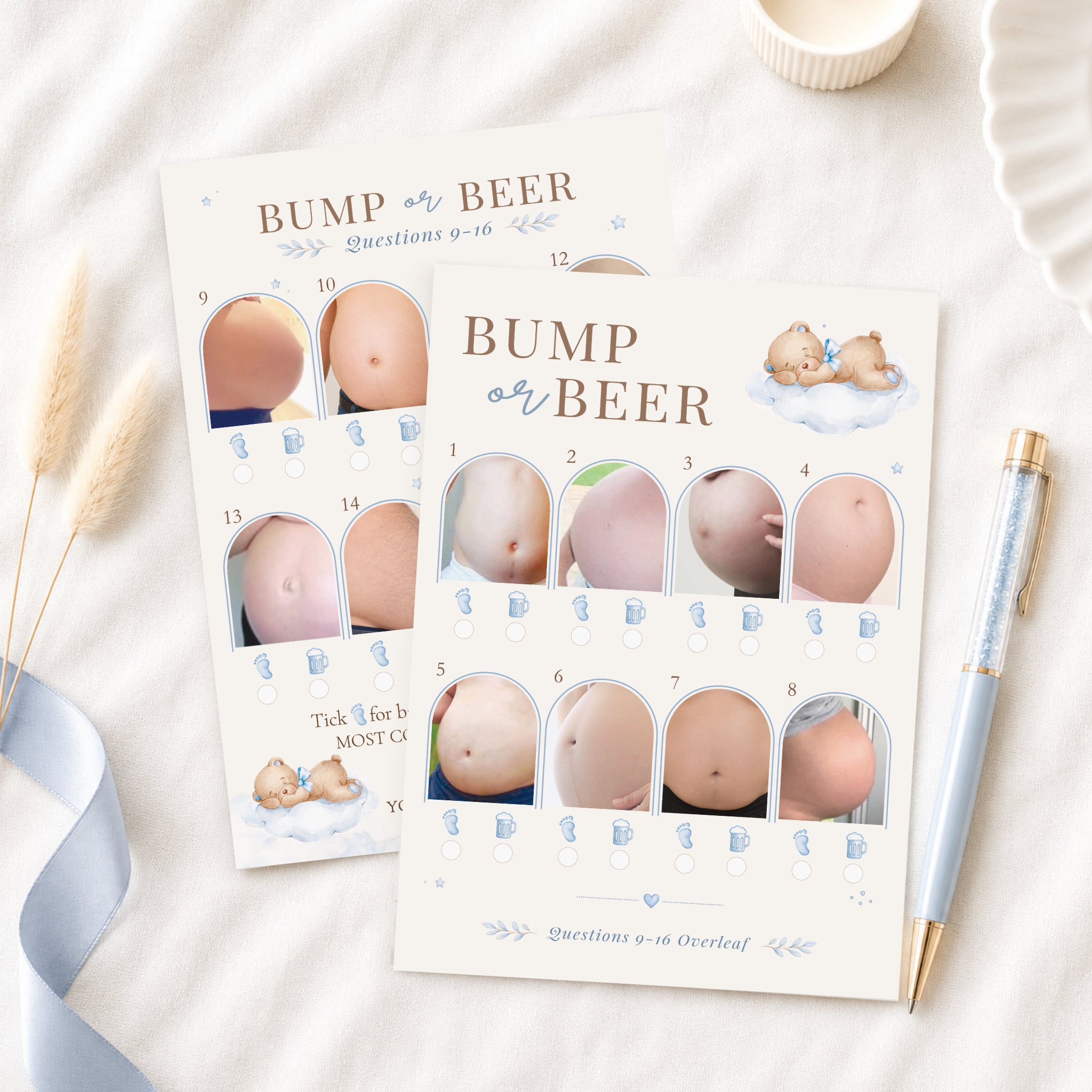Blue Teddy Bear Bump or Beer double-sided baby shower picture quiz cards displayed on a neutral flat lay with blue ribbon and luxury pen.