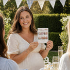 Pregnant mum holding a Blue Teddy Bear Bump or Beer picture quiz card during a baby boy baby shower in a garden with family and friends.