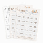 Two printed baby bingo game sheets with illustrated teddy bears and blue floral accents, shown on a clean white background.