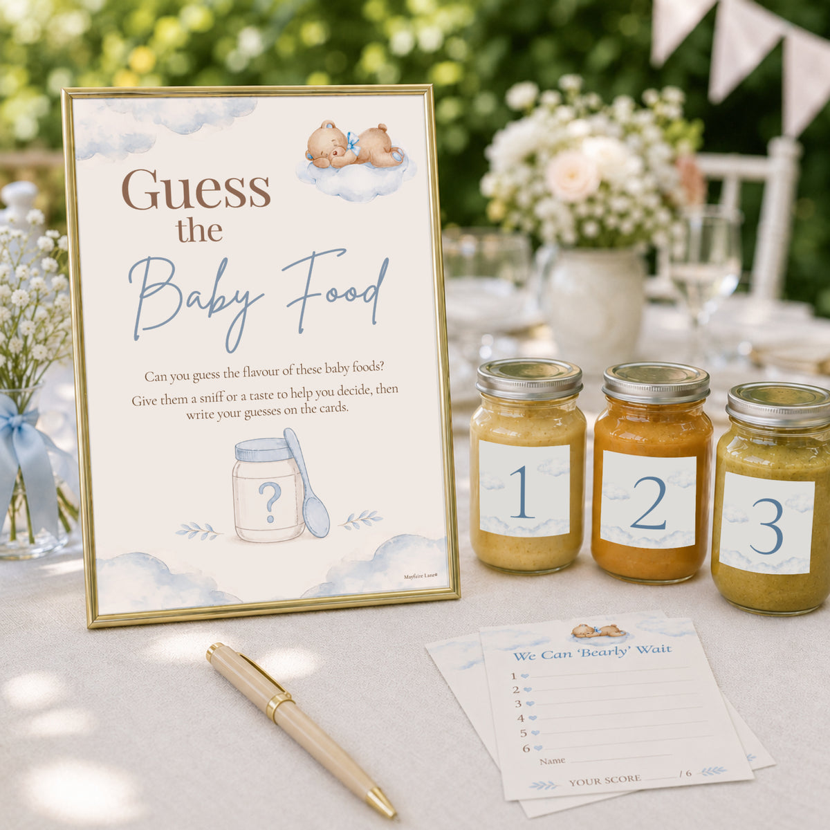 Blue teddy bear Guess the Baby Food baby shower game with A4 sign, numbered baby food jars and guest scorecards in lifestyle set up on decorated table