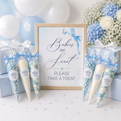 Blue bow baby shower favour sign displayed with sweet cones and matching thank you stickers, baby boy treat table decoration idea
