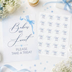 Flat lay of Blue Bow baby shower favour sign which reads 'Babies are Sweet please take a treat and 51mm Ready to Pop stickers on baby shower table
