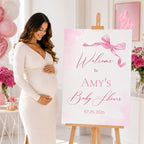 Pregnant mum standing beside personalised Little Bow Pink baby shower welcome sign featuring elegant blush pink coquette bow theme, customised baby girl shower entrance display and photo backdrop.