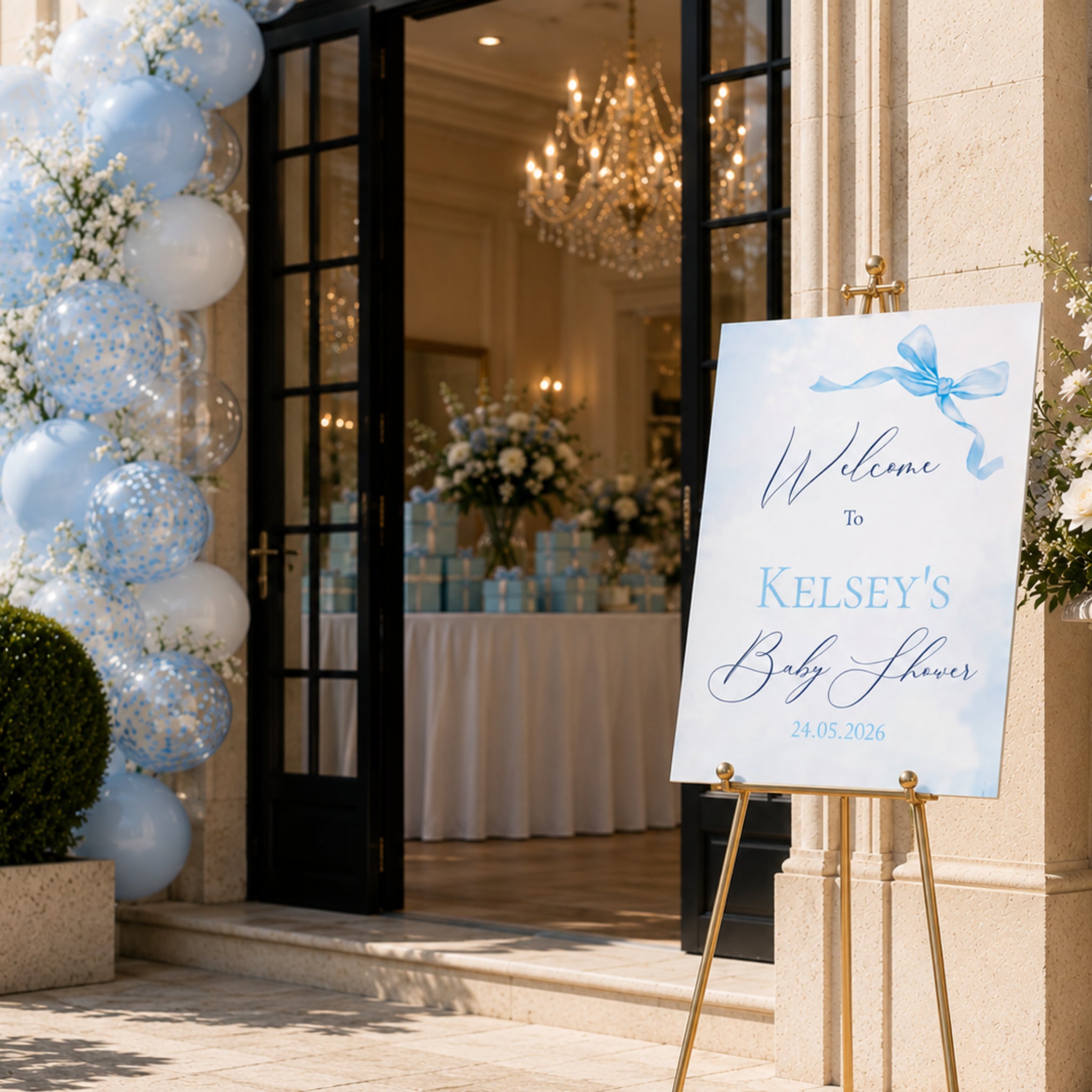 Little Bow Blue personalised baby shower welcome sign displayed outside venue entrance with blue balloon arch and elegant baby boy decorations.