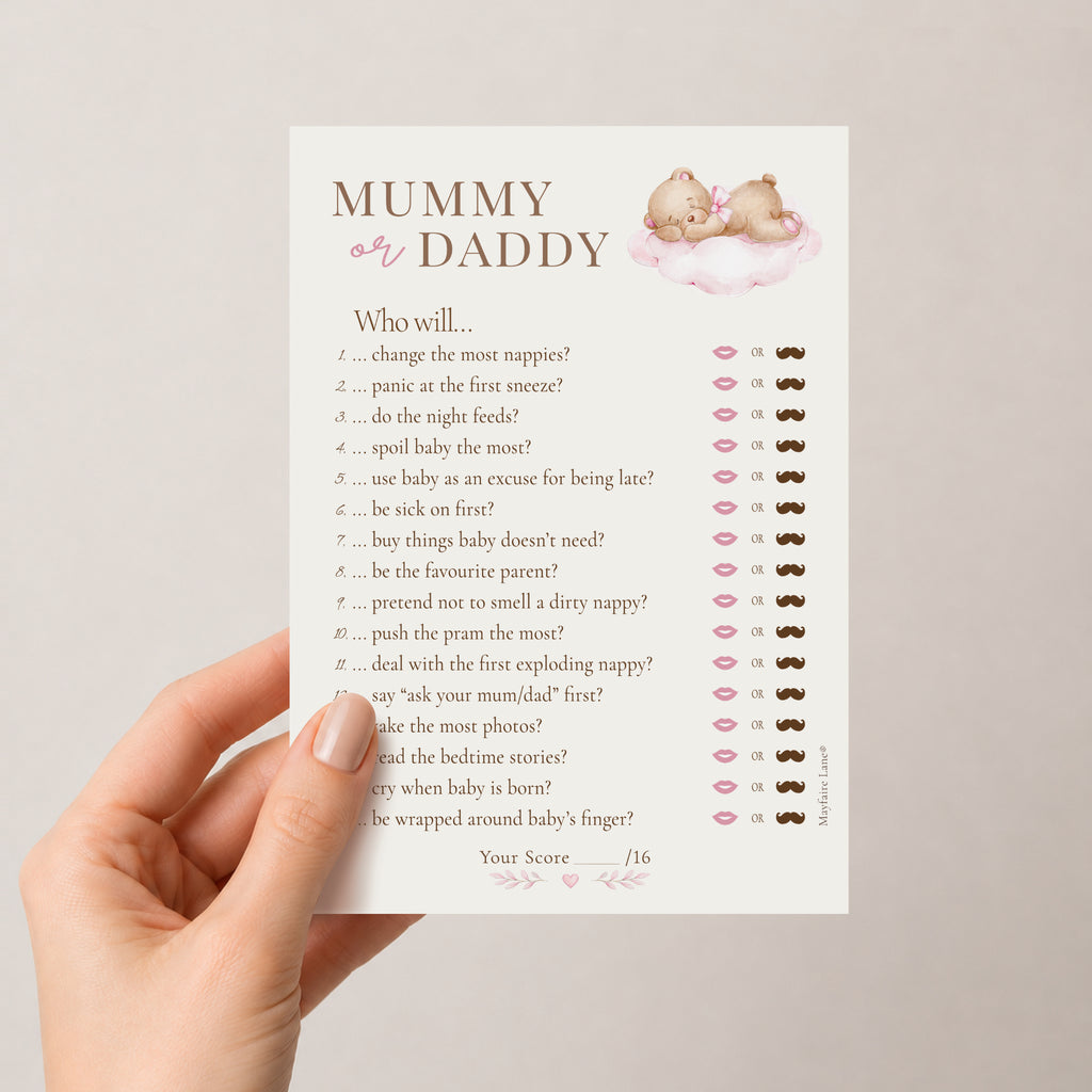 A hand holds a printed baby shower game card titled 'MUMMY or DADDY'