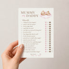 A hand holds a printed baby shower game card titled 'MUMMY or DADDY'