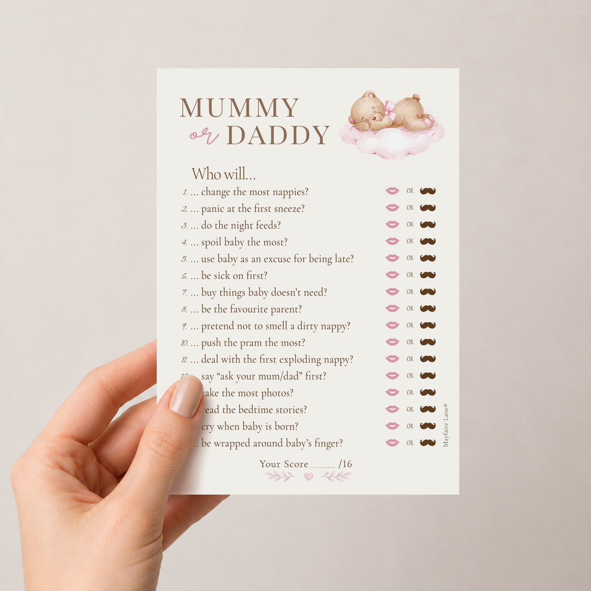 A hand holds a printed baby shower game card titled 'MUMMY or DADDY'