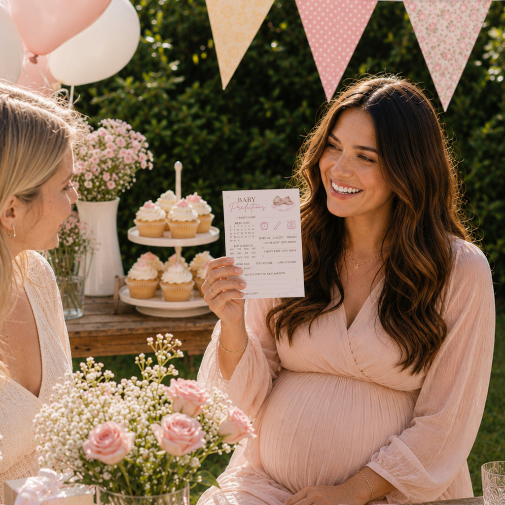 Pregnant mum holding Pink Teddy Bear Baby Prediction Card during an outdoor baby girl teddy bear baby shower with guests.