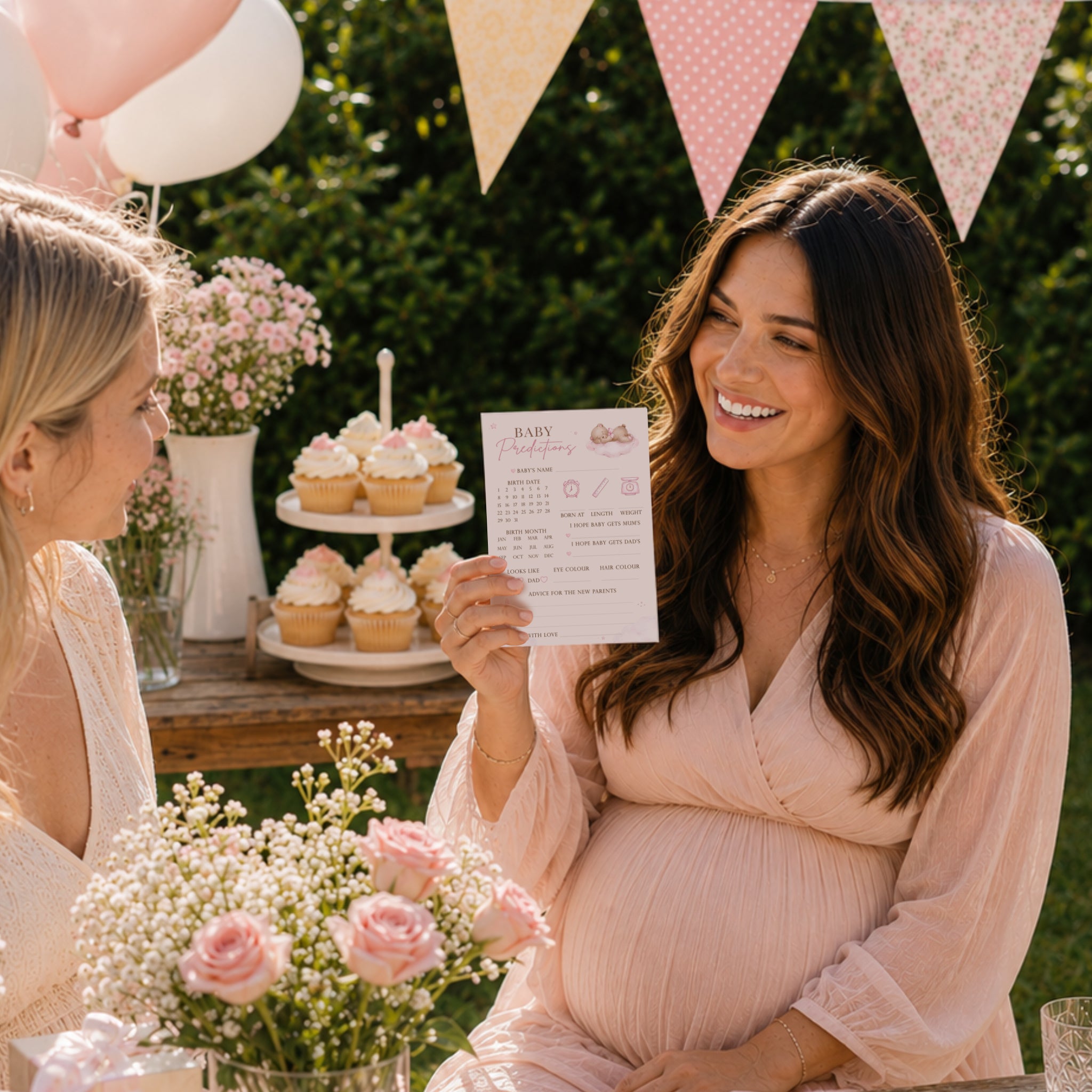 Pregnant mum holding Pink Teddy Bear Baby Prediction Card during an outdoor baby girl teddy bear baby shower with guests.