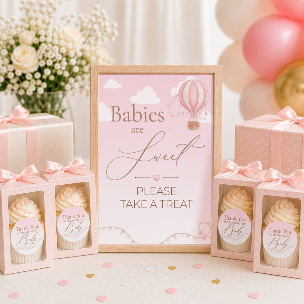 Pink hot air balloon baby shower favour sign with thank you stickers on baby themed cookie favours
