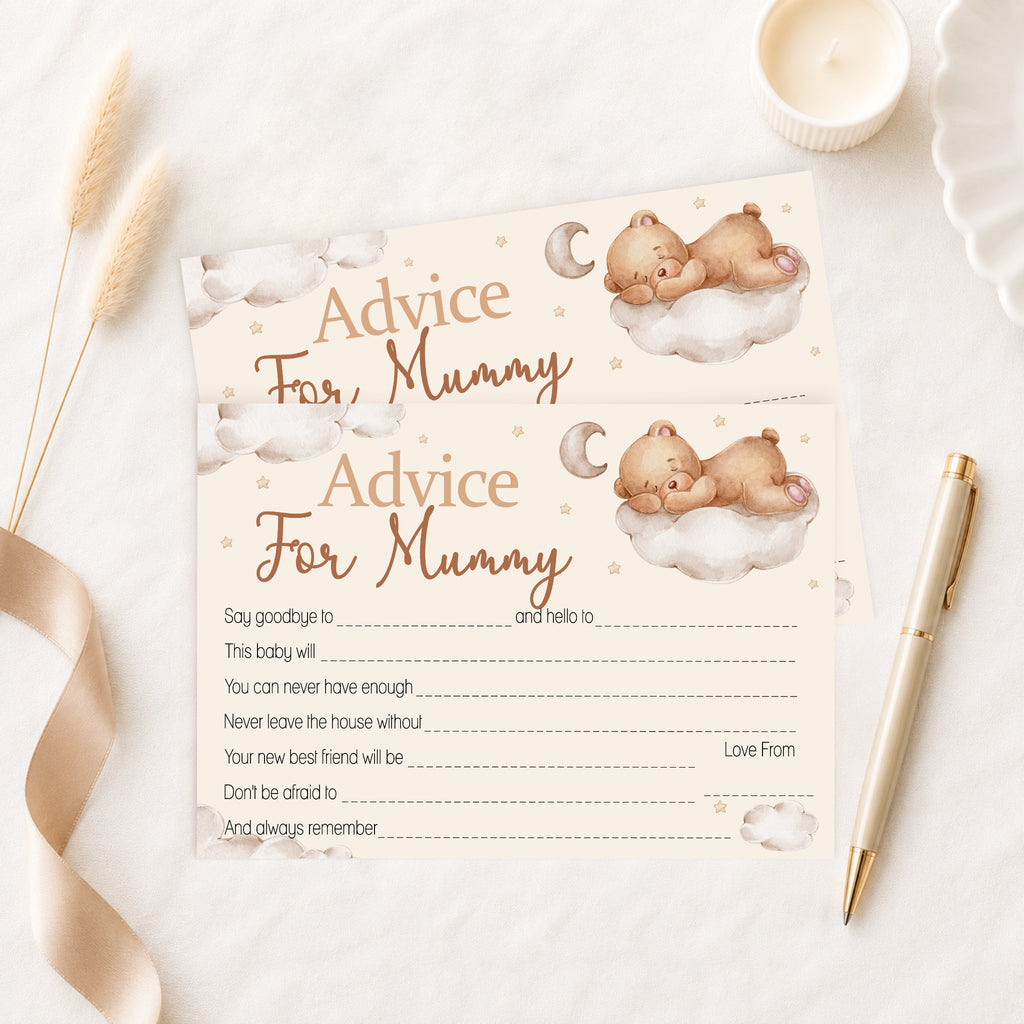 A baby advice card for 'Mummy' styled in a flat-lay arrangement with a gold pen, a lit candle, dried grass, and a beige ribbon on a white marble surface. The card features watercolor illustrations of a teddy bear sleeping on a cloud with a crescent moon, with text fields for writing personal messages.
