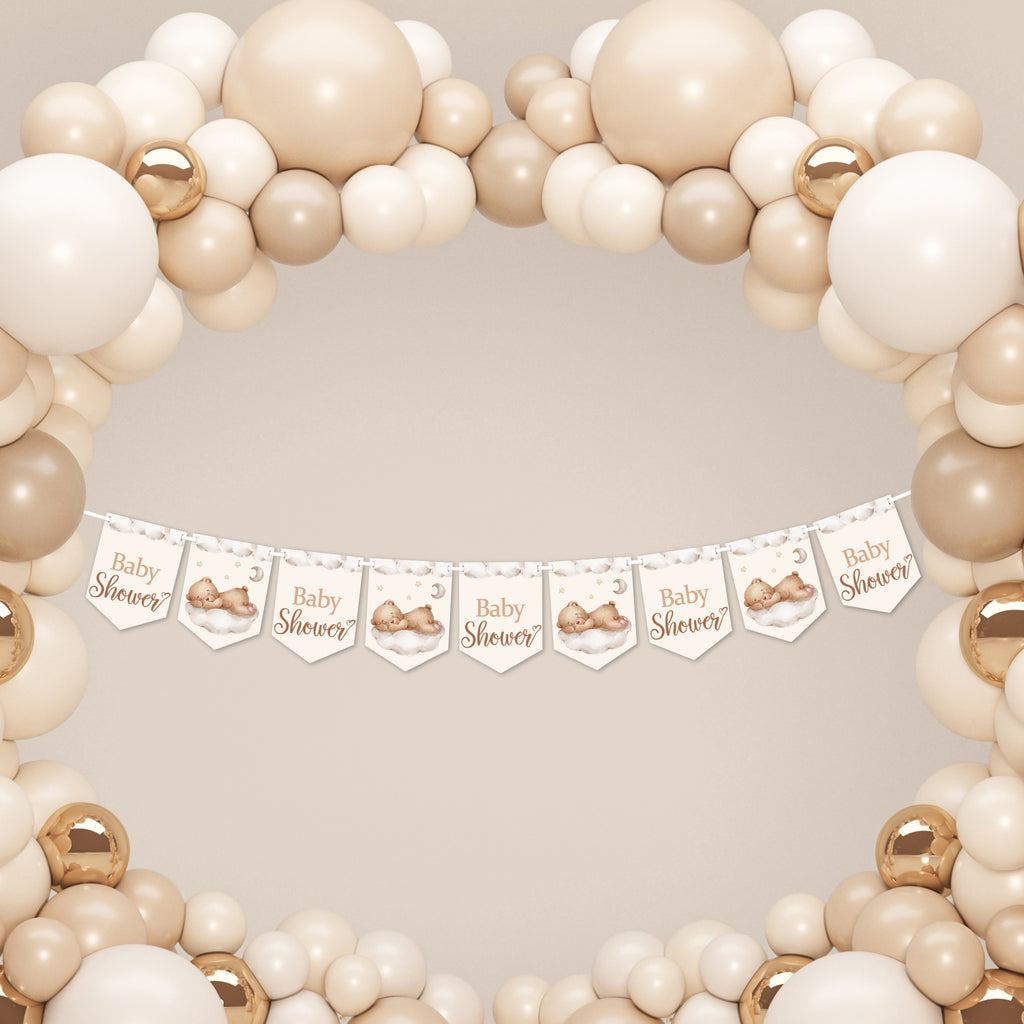 Neutral teddy bear baby shower banner hanging beneath a cream and beige balloon arch for a stylish baby shower backdrop.