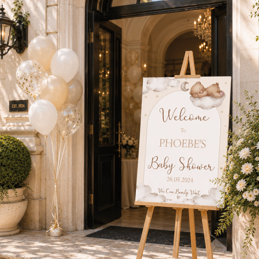 Large personalised Teddy Bear Baby Shower Welcome Sign displayed outside baby shower venue entrance with balloons and teddy themed decorations.