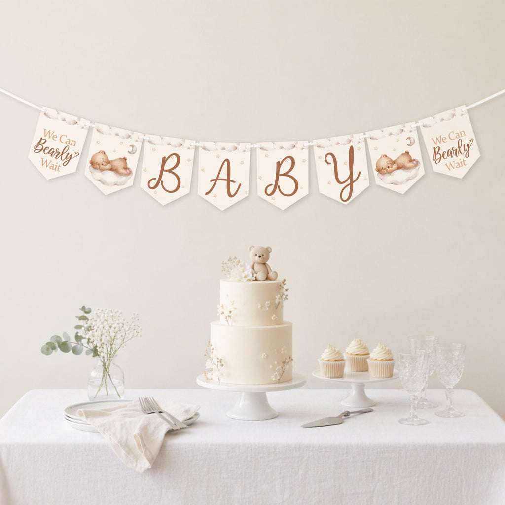 Teddy bear baby shower banner bunting displayed above a neutral baby shower dessert table with teddy bear cake.