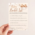 Completed teddy bear baby shower bucket list keepsake card showing guest ideas for baby's first year memory activity