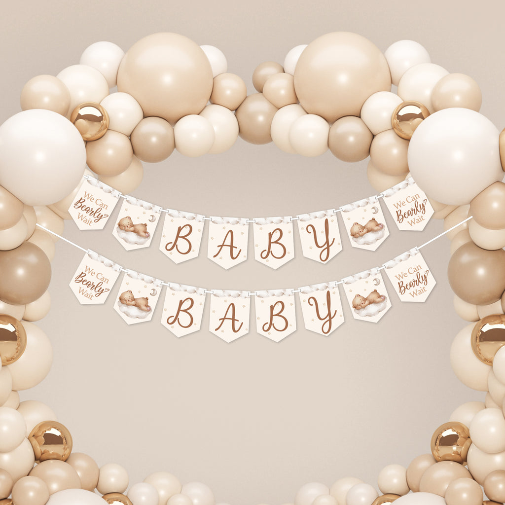 Two teddy bear baby shower banners displayed beneath a cream balloon arch for large baby shower venue decoration.