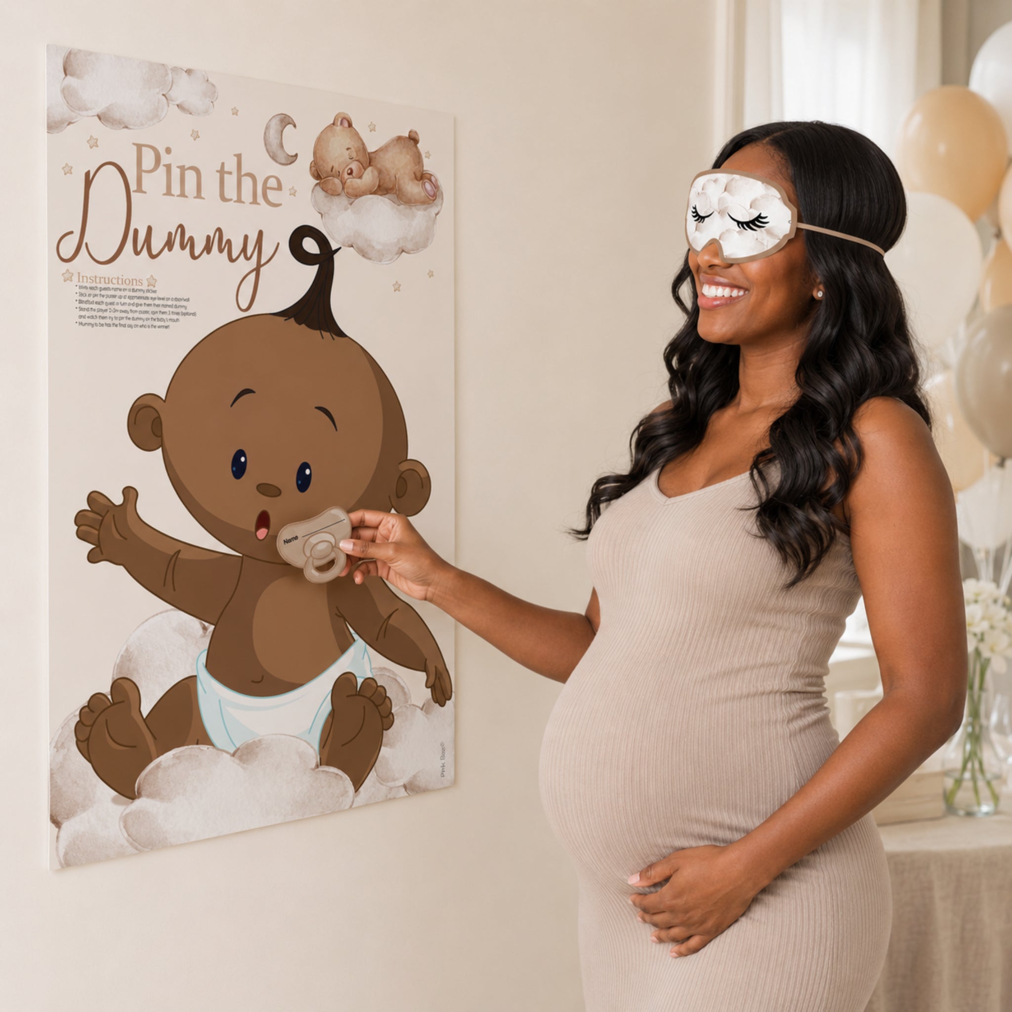 Pregnant woman playing the Ethnic Teddy Bear Pin the Dummy baby shower game while wearing the included blindfold.