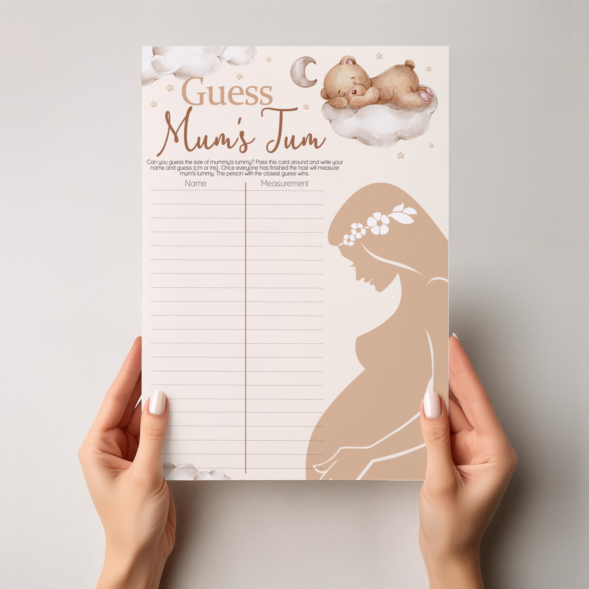 Person holding Teddy Bear Guess Mum's Tum baby shower game showing full A4 size.