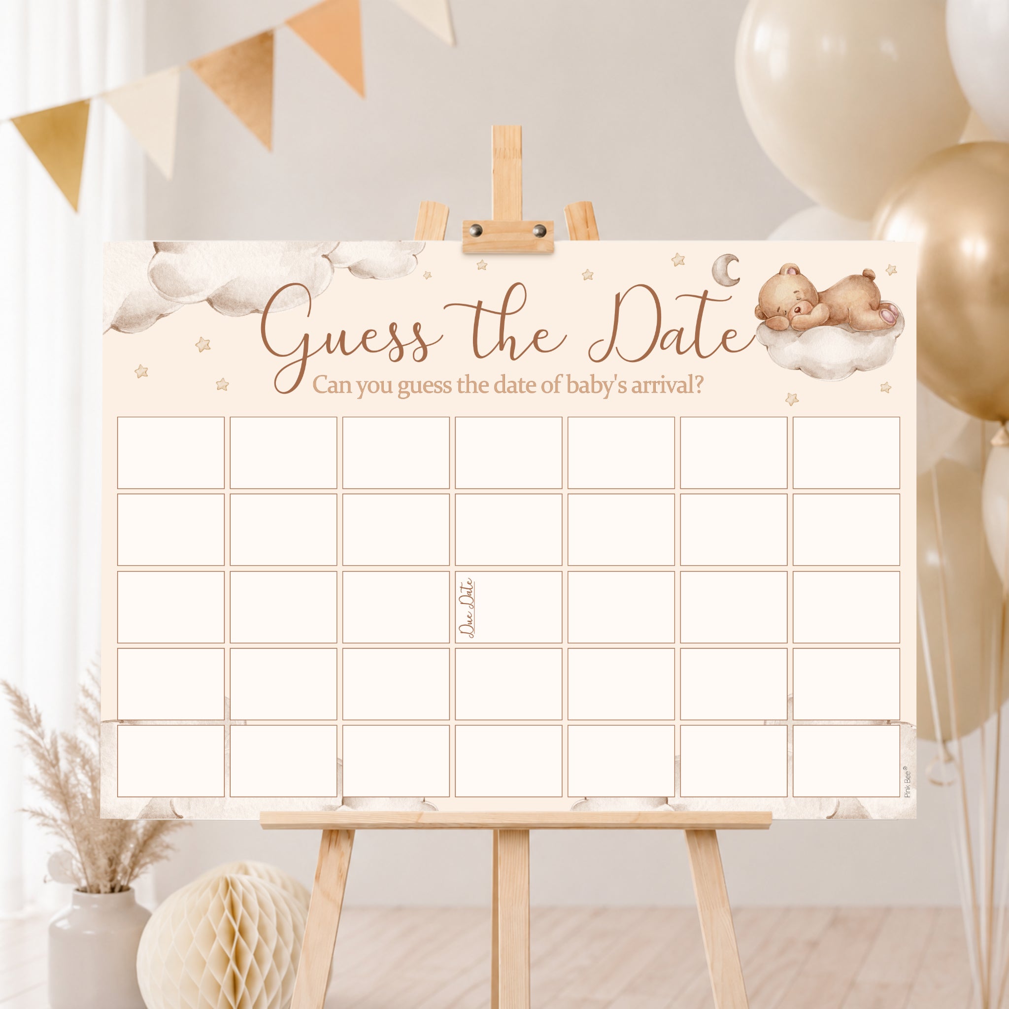 Teddy Bear Guess the Date baby shower poster displayed on a wooden easel with neutral cream and gold baby shower decorations.