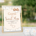 Teddy Bear Guess the Sweet Mess baby shower sign displayed in a gold frame beside numbered nappies for a neutral teddy themed baby shower.