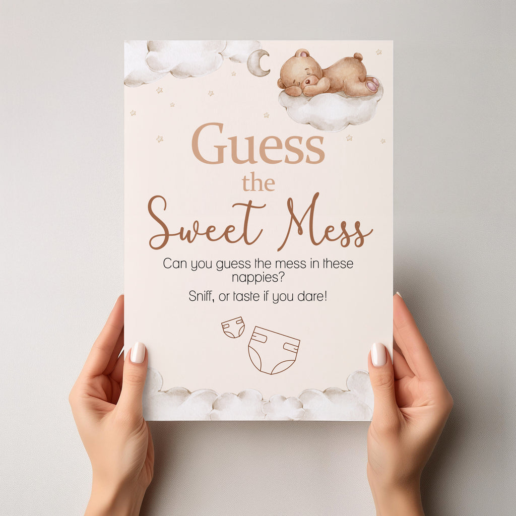Person holding Teddy Bear Guess the Sweet Mess A4 baby shower game sign showing premium British printed quality.