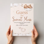 Person holding Teddy Bear Guess the Sweet Mess A4 baby shower game sign showing premium British printed quality.