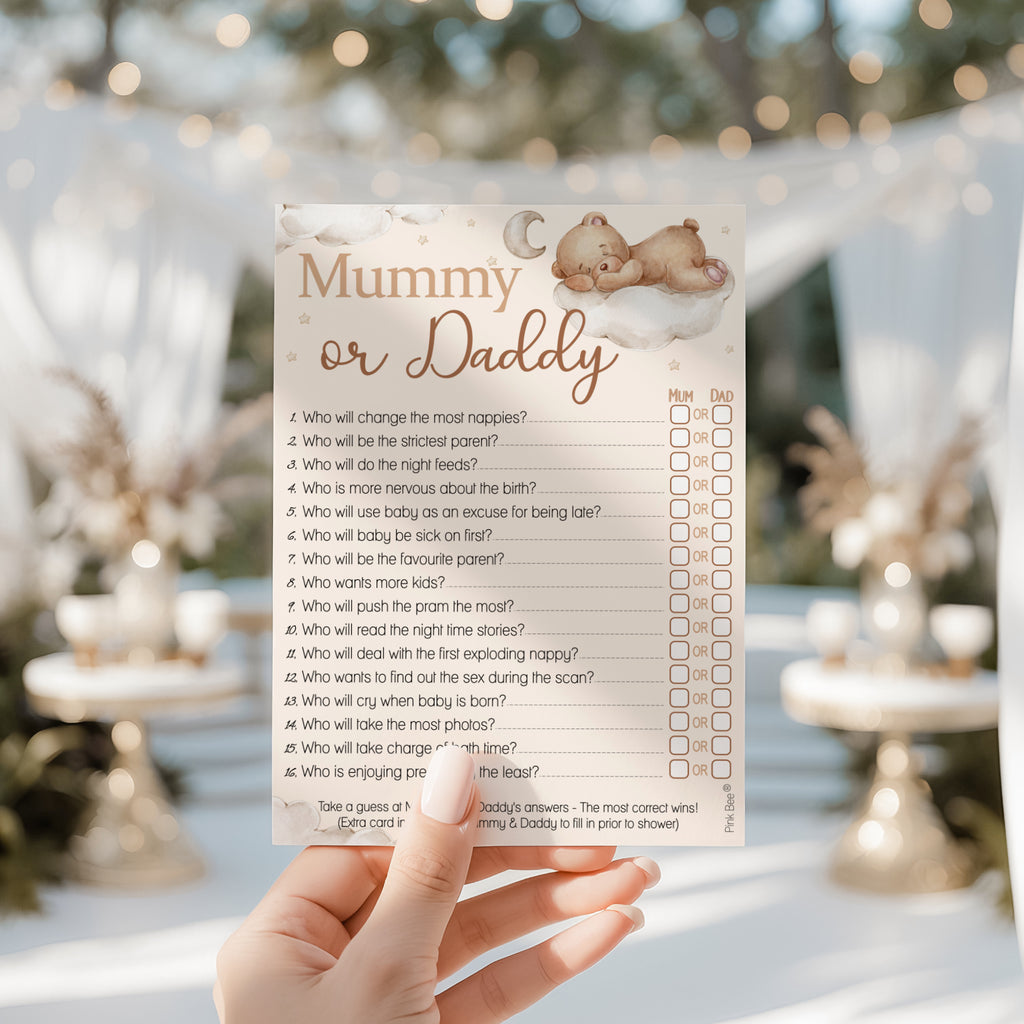 Hand holding Teddy Bear Mummy or Daddy baby shower game card at a neutral teddy themed baby shower party.