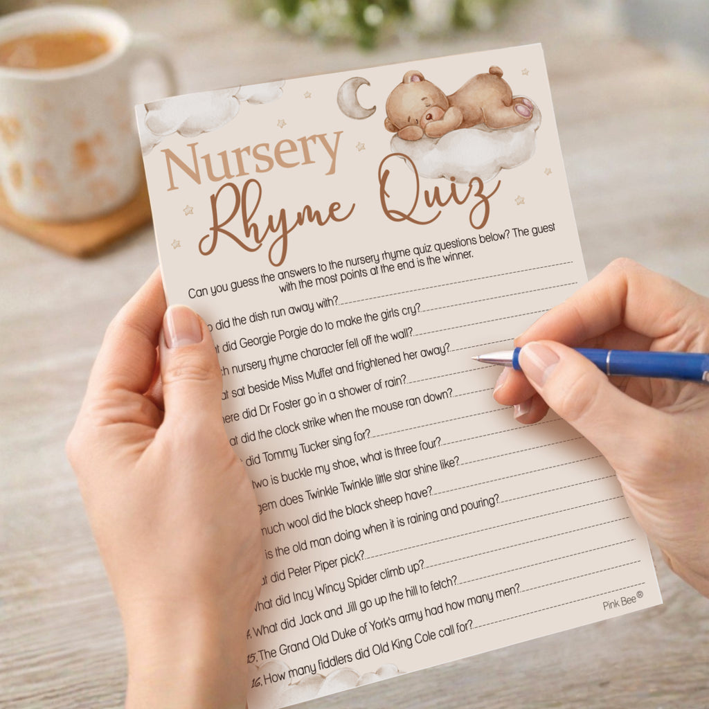 Guest completing the Teddy Bear Nursery Rhyme Quiz baby shower game during a neutral teddy themed baby shower.