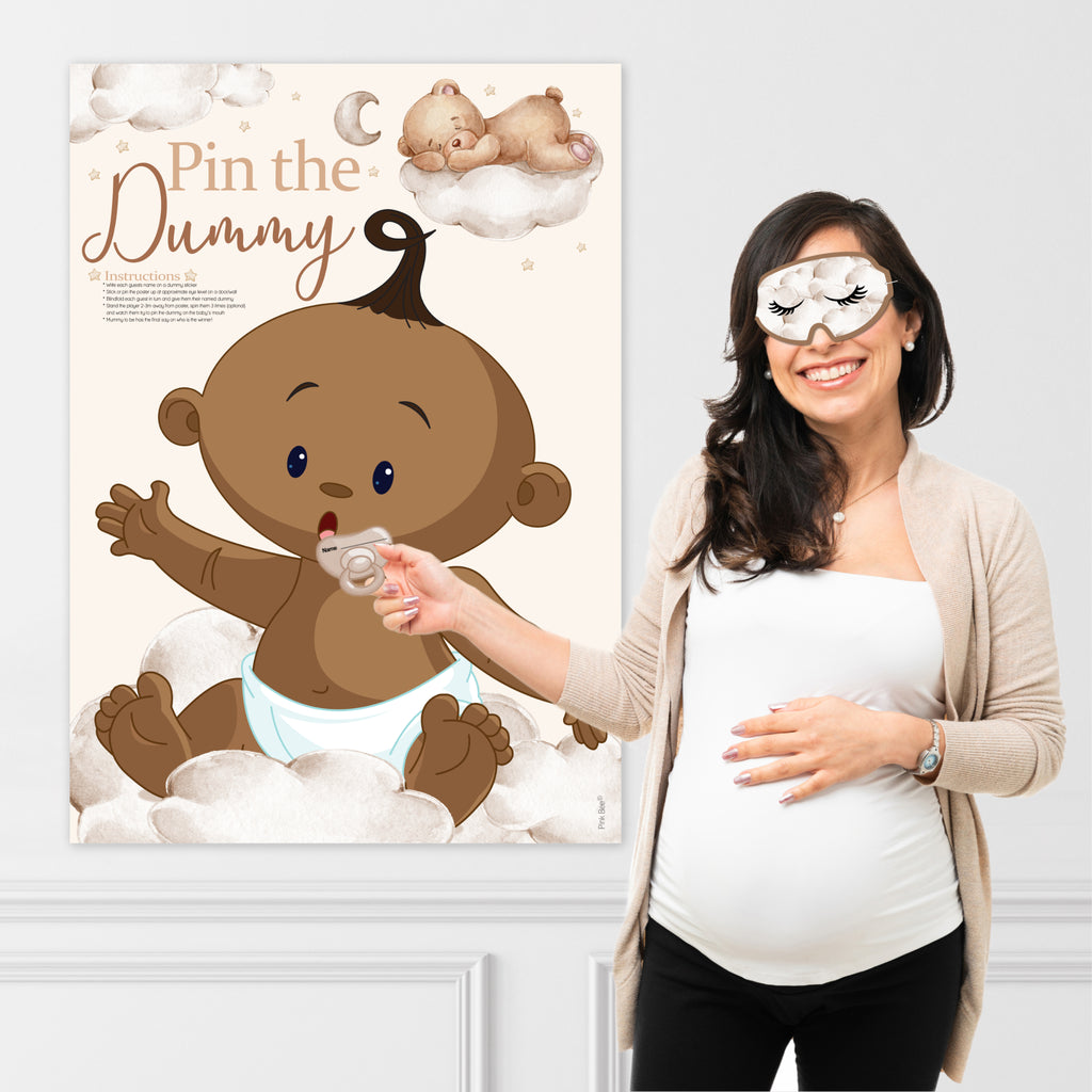 Baby shower guest playing the Ethnic Teddy Bear Pin the Dummy game using the included blindfold and dummy sticker.
