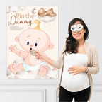 Pregnant woman playing Teddy Bear Pin the Dummy baby shower game using the included blindfold and dummy sticker.